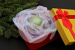 The gift box contains a Christmas present, a Christmas tree toy.