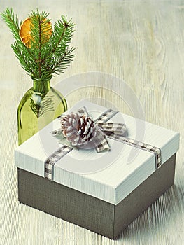 Gift box decorated with ribbon in a cage on a wooden light back