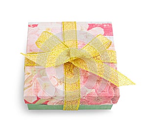 Gift box with festive floral prints and golden ribbon bow