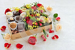 Gift box with flowers and candies made of chocolate