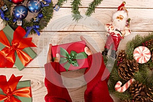 Gift box in girl`s hands. Open presents. Christmas background