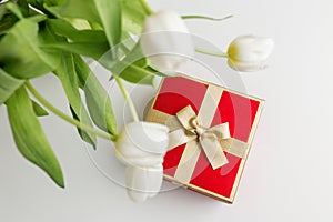 Gift Box with Gold Ribbon and White Tulips. Top view