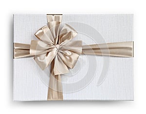 Gift box with golden ribbon bow isolated on white background, top view
