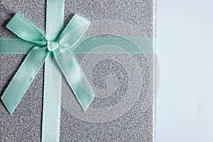 Gift box with green ribbon on white background, top view.