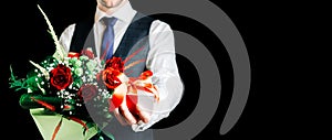 Gift box hand. Happy young business man holding surprise giftbox present with luxury rose flower bouquet  on