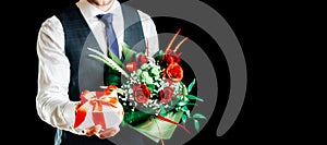 Gift box hand. Happy young business man holding surprise giftbox present with luxury rose flower bouquet isolated on