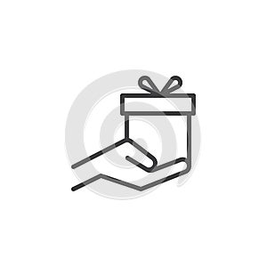 Gift box in hand outline icon