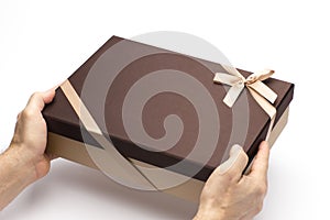 The gift box in hands to hold on a white background.