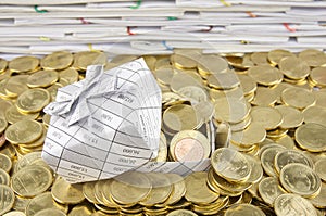 Gift box in heap of gold coins