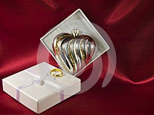 Gift box with a heart shaped Christmas decoration