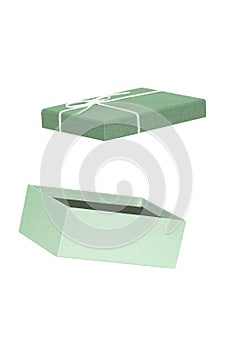 Gift box isolated. Close-up of a green opened present or gift box with white ribbon bow isolated on a white background. Birthday,