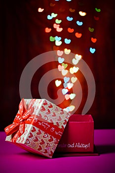 Gift box open shaped heart with Defocused bokeh colorful lights