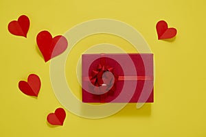 Gift Box and Paper red hearts on a yellow