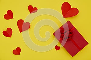 Gift Box and Paper red hearts on a yellow