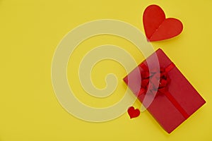 Gift Box and Paper red hearts on a yellow