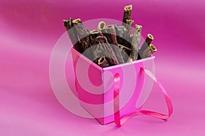 Gift Box of pet treats on a pink background.