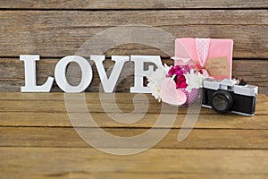 Gift box, photo frame, vintage camera and flower vase