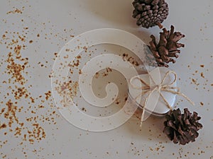 gift box and pine cones on old rusty iron background for copy space