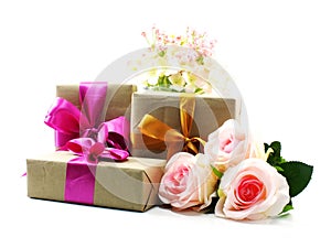 Gift box with pink ribbon bow and rose flower