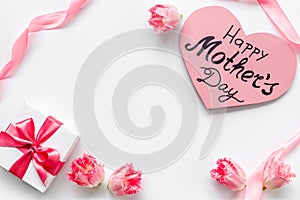Gift box with pink ribbon over Happy Mothers day greeting card