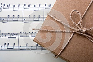 Gift box placed on paper with musical notes