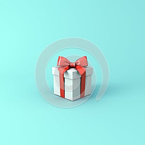 Gift box or Present box with red ribbon and bow isolated on light blue green pastel color background