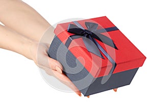 Gift box with a red lid and a blue bow in hand