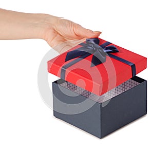 Gift box with a red lid and a blue bow in hand