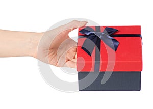 Gift box with a red lid and a blue bow in hand