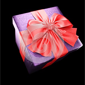 Gift box with red ribbon on black background. 3d
