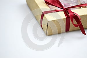 Gift box with red ribbon bow.