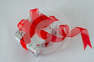 Gift box with red ribbon and bow on white background