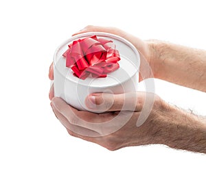 Gift box with red ribbon in a man's hands