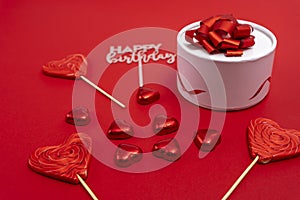 gift box with a ribbon and a bow, heart-shaped chocolates