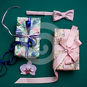 Gift box with ribbon on green backdround