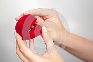 Gift box with a ring in hand