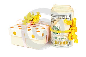 Gift box and roll of dollars.