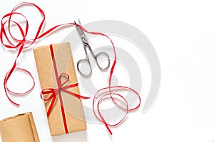 Gift box, scissors and a ribbon on a white background