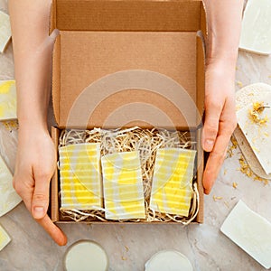 Gift box with set of natural soap in female hands. DIY soaps kit. Many various homemade bar soaps. Hygiene toiletries