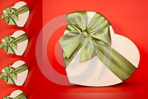 gift box in the shape of a heart tied with a green bow on a red background