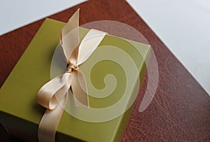Gift box in a simple business style on a leather folder for papers