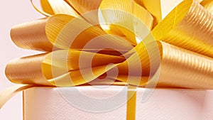 Gift box spinning with gold bow