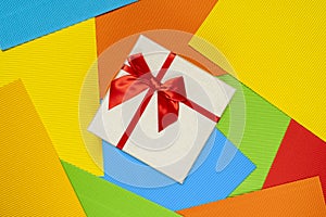 Gift box on the striped colored paper