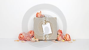 Gift box with a tag mockup, orange flowers