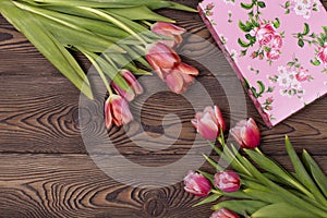 Gift box and tulip flowers on rustic table for March 8, International Womens day, Birthday or Mothers day, beautiful