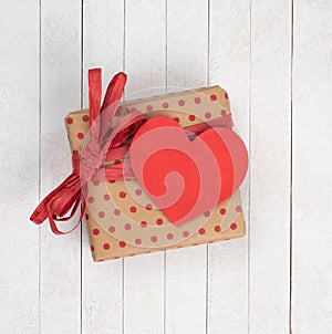A Gift box for Valentine`s Day that is wrapped and has a heart with copy space for your words or text.  It`s has an above view