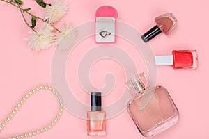 Gift box and women cosmetics on a pink background