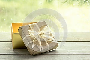 Gift box on wooden table on rainy day window background