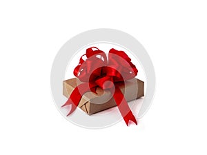 A gift box wrapped in brown craft paper, with a red ribbon and bow on a white, isolated background. concept celebration