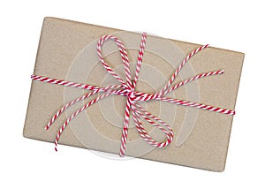 Gift box wrapped in brown recycled paper with red and white rope